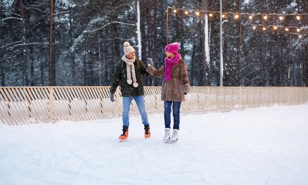 Couple ice skating outdoors, a fun and romantic thing to do during weekend trips from Minneapolis