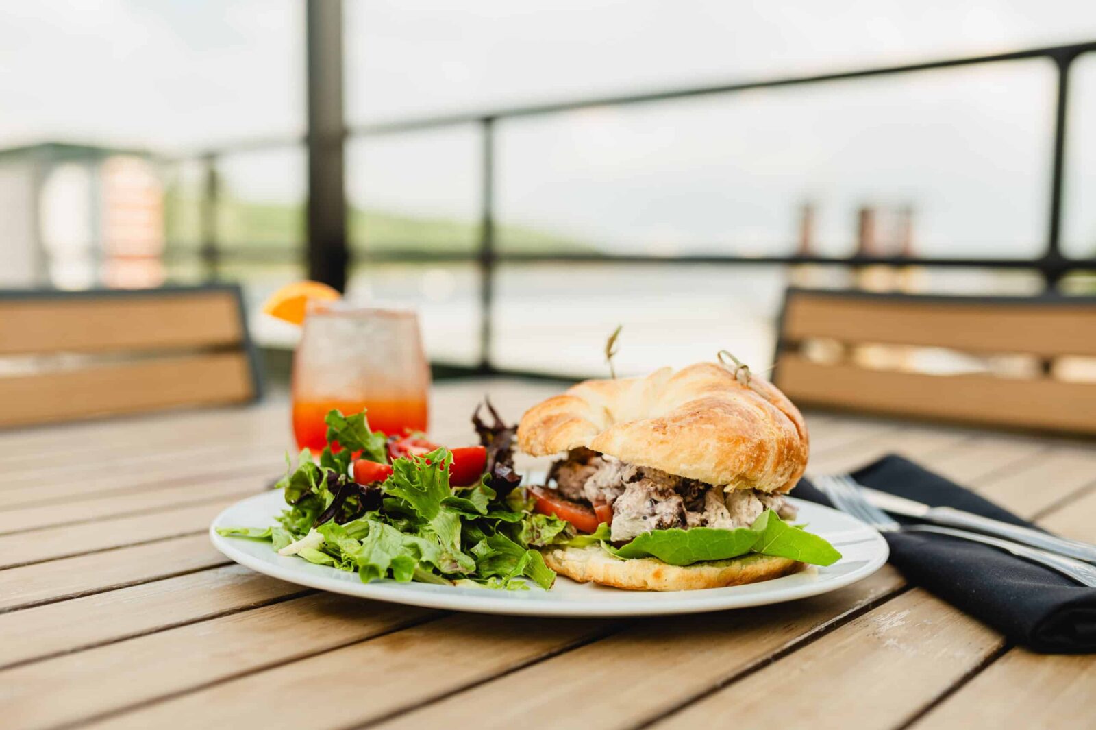 Sandwich and Cocktail on table at Papa's one of the best Stillwater Restaurants.