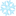 A blurry, light blue, six-pointed snowflake icon on a white background.