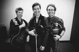 A black and white photo of three musicians holding an acoustic guitar, a fiddle, and a mandolin.
