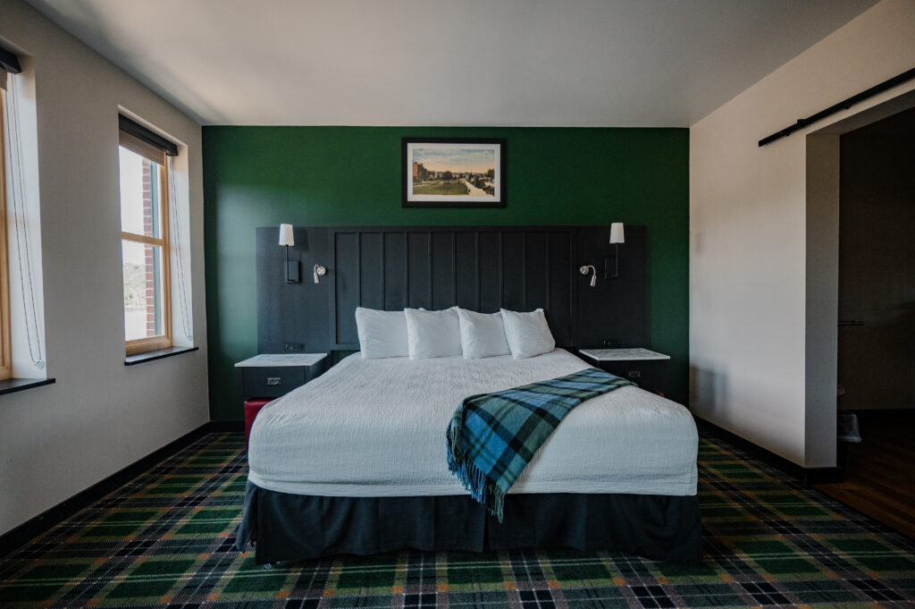 King suite at our inn features dark accent wall and king bed, perfect for weddigs in Stillwater MN