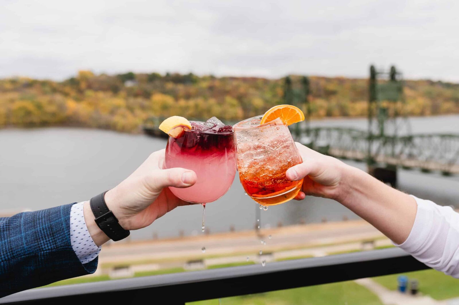 Three Exceptional Restaurants in Stillwater Under One Roof 1 Couples makes toast with cocktails at Papa's, one of the best Stillwater restaurants.