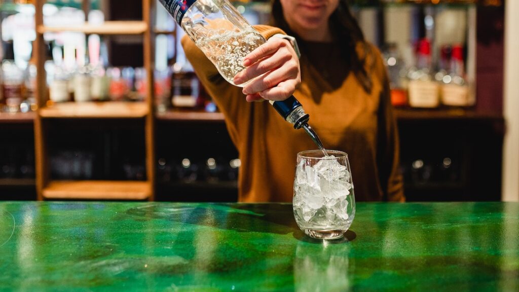 Our Favorite Things to do in Stillwater this Winter 2 Things to do in Stillwater, bartender pouring a drink at Charlie's Irish Pub in the Water Street Inn