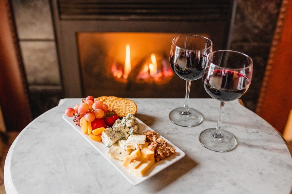 Our Favorite Things to do in Stillwater this Winter 3 Things to do in Stillwater, the Water Street Inn cozy glass of wine and charcuterie board by the fire