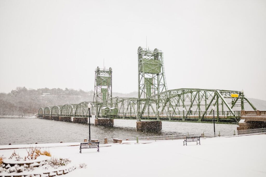 Our Favorite Things to do in Stillwater this Winter 1 Things to do in Stillwater, shot of the historic lift bridge with snowfall and grey stormy clouds